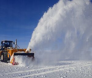 Machinery out on the runway blowing snow off it.