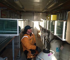 Mat in container full of fish tanks.