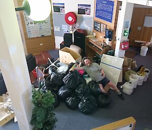 Watto on pile of garbage in the wallow, which needs to be returned to Australia.