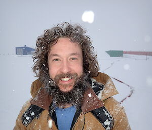 Ducky standing outside in the snow with icy hair and beard.