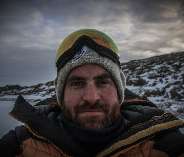 Simon Jodrell standing outside with a hill in the background.