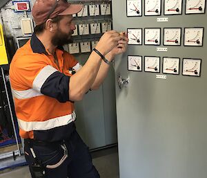 Man fixing a switch board.