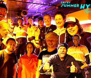A photoshopped image of 15 people in a group shot in neon lit hydroponics shed