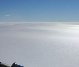 White flat expanse to the horizen with blue sky above