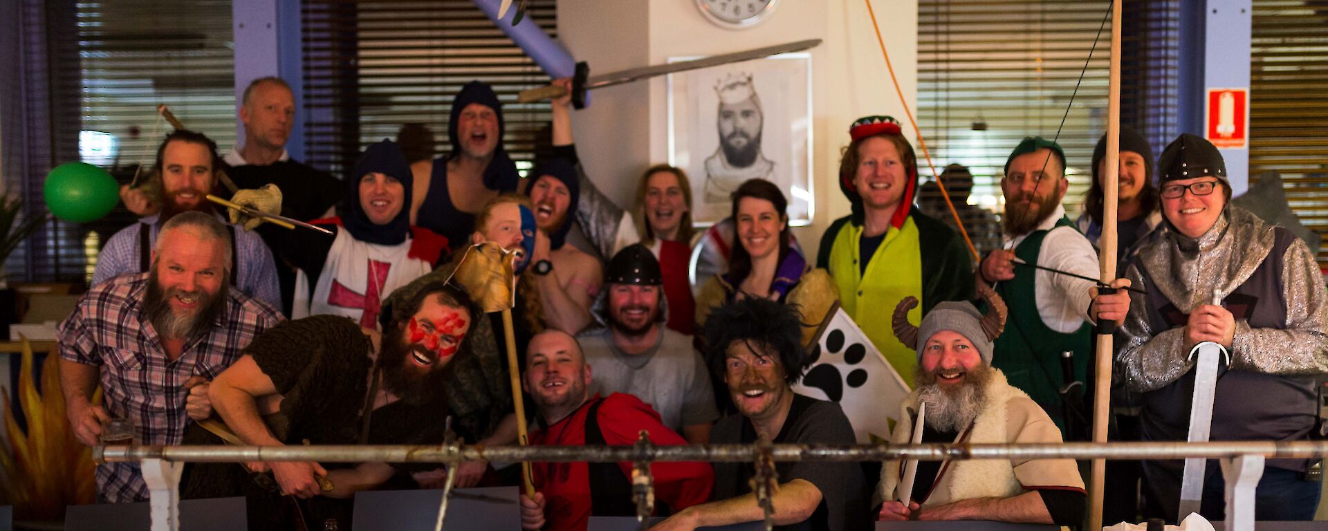 People gathered together for a grop photo, most in different medieval outfits