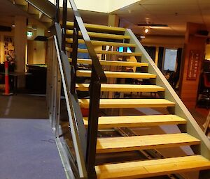 Staircase from below, wooden treads, dark grey balustrade