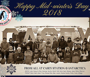Midwinter greeting with photo of the team in front of the Casey sign in old world explorer outfits and in sepia, greeting reads “happy midwinter’s day 2018 from all at Casey Station, Antarctica” and has this season’s badge and the names of all the Casey expeditioners