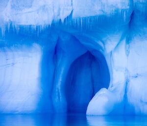 Close up of the side of an iceberg, bright blue and white tones