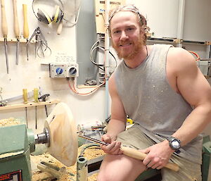 Carpentry workshop, man working at wood lathe