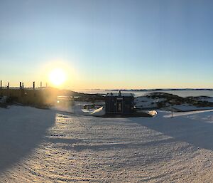 Panorama shot of Casey station from the Operations Building front deck, showing building, bay and blue skies