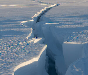 Close up of crack in the sea ice at front and then extending off into the distance