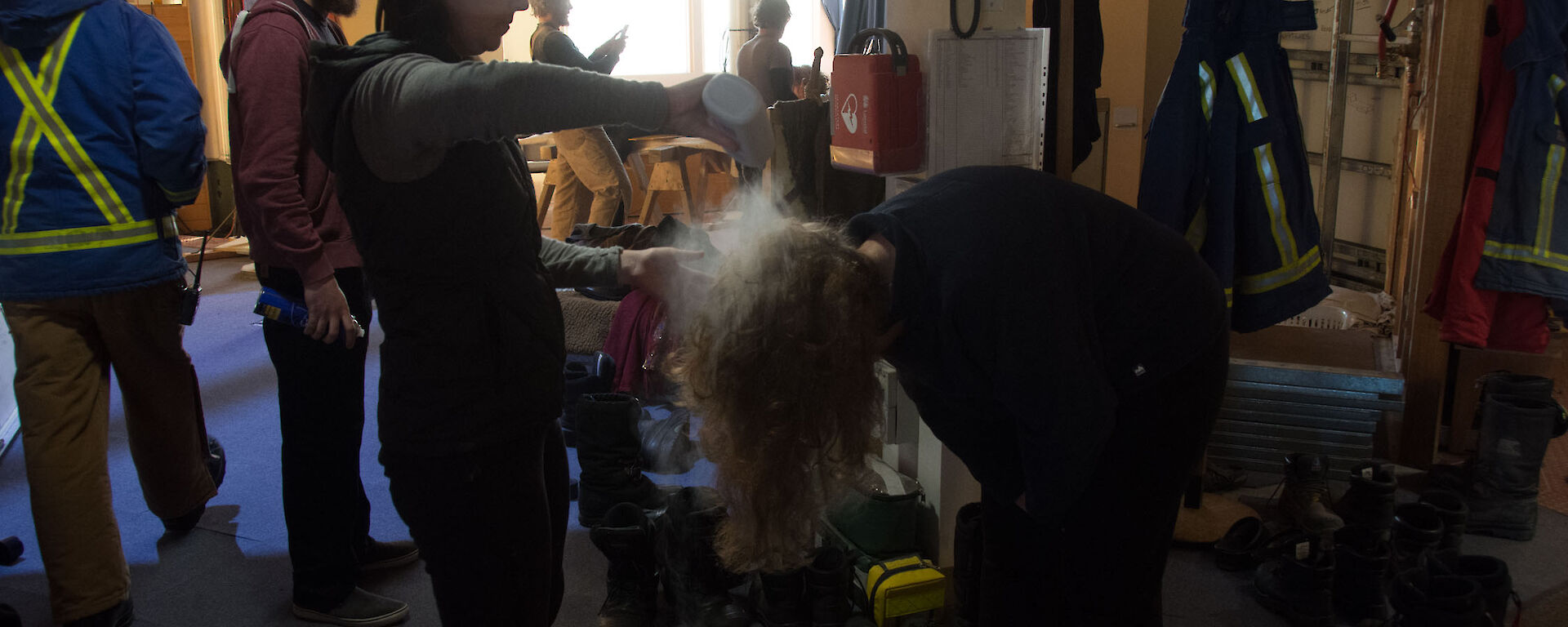 Woman putting talcom powder through hair or person bent over