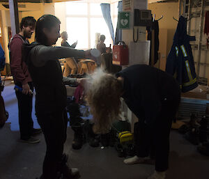 Woman putting talcom powder through hair or person bent over