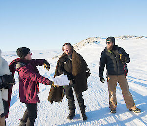 Two men dressed as knight king and Jon Snow getting acting direction form woman with camera man looking on