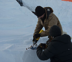 Filming of small paper men being burnt by gas torch covered by paper dragon