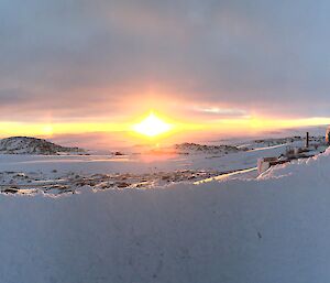 Panoramic photo overlooking Newcomb bay at sunrise with atmospheric conditions making sundogs either side of the sun rising