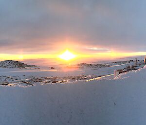 Panoramic photo overlooking Newcomb bay at sunrise with atmospheric conditions making sundogs either side of the sun rising