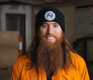 Headshot of man in his hi-vis shirt, wearing AAD beanie, with long auburn beard.