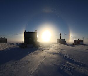 Solar halo in sky above Wilkins camp buildings