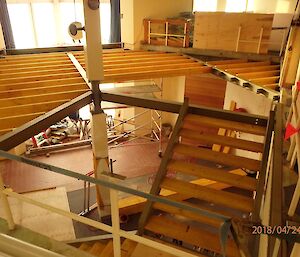Void space being filled with beams and rafters for new floor, centre picture the staircase leads down to next level