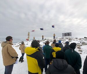 Three flags being rasied, Australian, New Zealand and England at Remembrance Day Ceremony