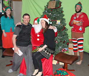 Expeditioners dressed up in elf costumes celebrating christmas distributing presents