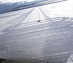 Ski grooming vehicles working across a ski landing area on the plateau above Davis