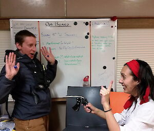 Expeditioner points a rubber band gun at another expeditioner during mexian night