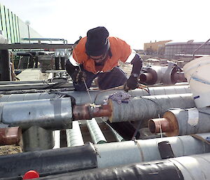 Tradesmen soldering on pipework