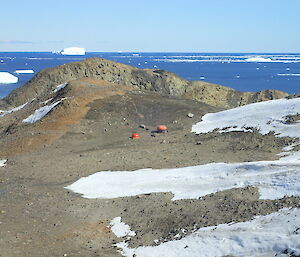 Red huts on small rocky island