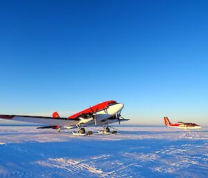 Two aeroplanes parked at ski landing area