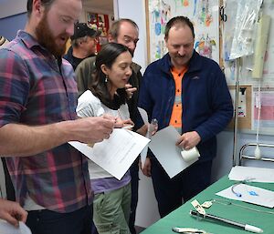 Expeditioners reviewing surgical instruments