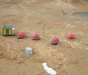 Antarctic huts on brown rocky ground. Law Base in Eastern Antarctica