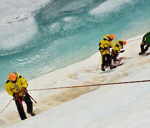 Four expeditioners practising abseiling