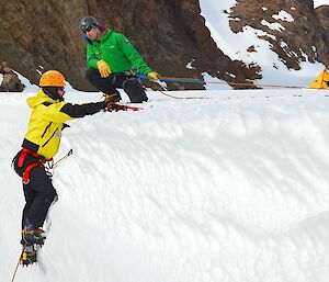Expeditioners being instructed on ice climbing by a field training officer