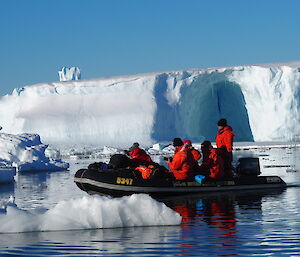 inflatable boats beside icebergs