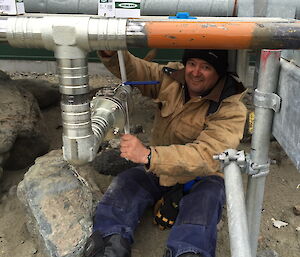Tradesman installing a fuel pipe