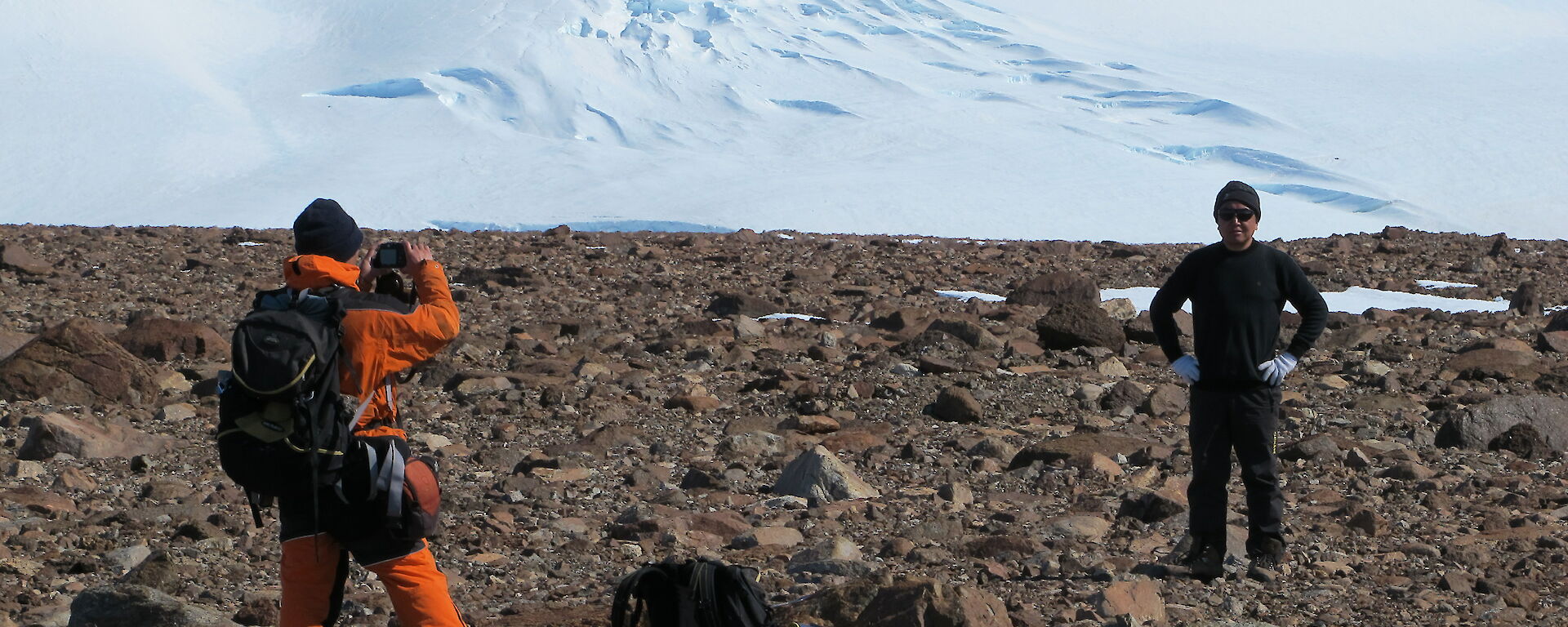 Two expeditioners on rocky terrain