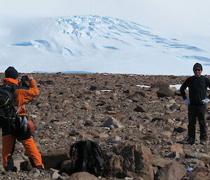 Two expeditioners on rocky terrain
