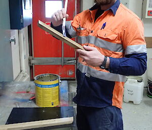 Expeditioner staining his woodwork