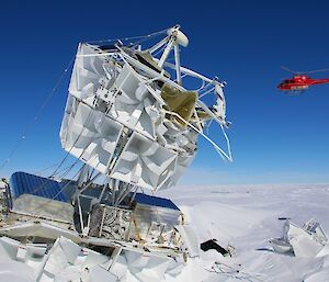 helicopter hovering past the ANITA III antenna structure