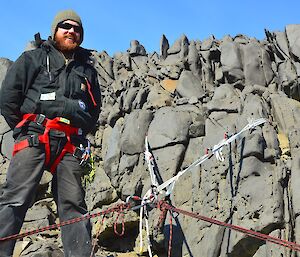 Expeditioner installing rock anchors