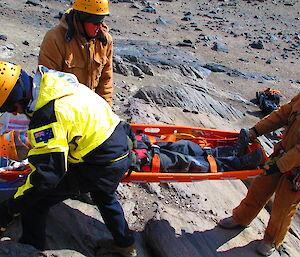 Davis expeditioners lowering a stretcher in a search and resuce exercise