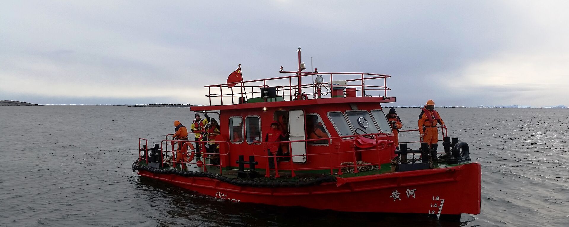 Brightly painted CHINARE work boat docking at Davis wharf