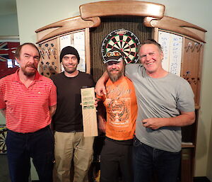 Expeditioners pose at darts championship.