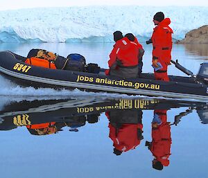 Inflatable dinghy with crew of three navigating smooth waters