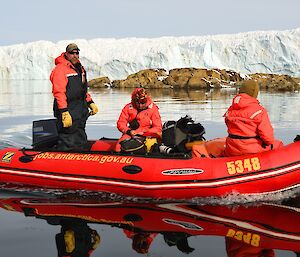 Boat crew navigating calm waters on an inflatable dinghy