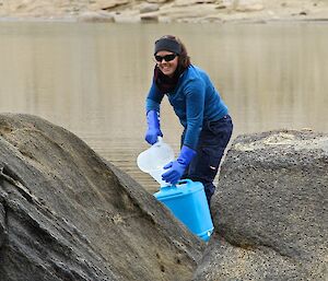 Expeditioner collecting water samples