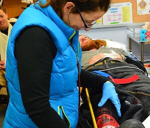 Expeditioner receiving medical treatment from a doctor during a search and rescue exercise