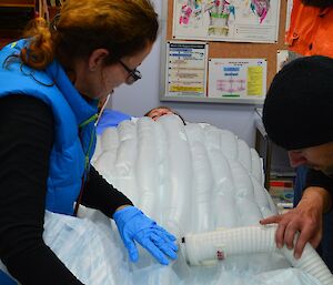 Expeditioner being treated by surgical assistants during a medical exercise